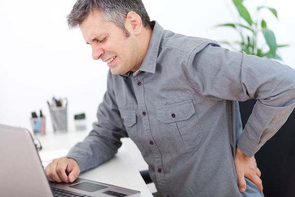 Ankylosing spondylitis A man holding his back in pain