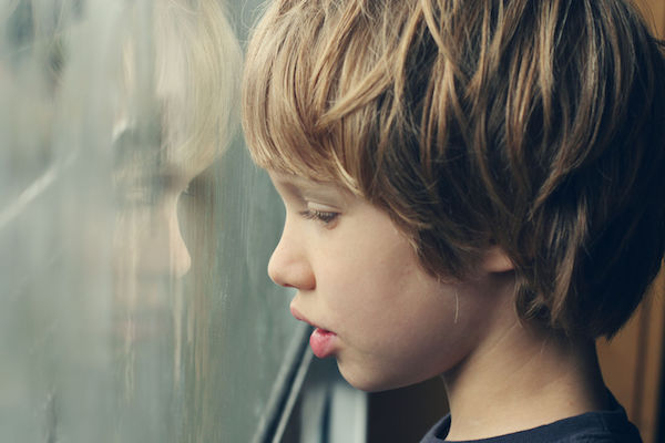 Autism A boy with autism looking out a window