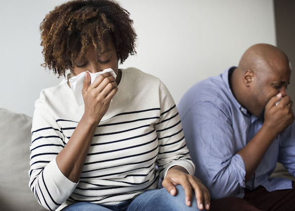 Cough A woman coughing into a tissue
