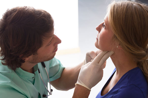 Lymphoma A woman having her lymph nodes checked by a doctor